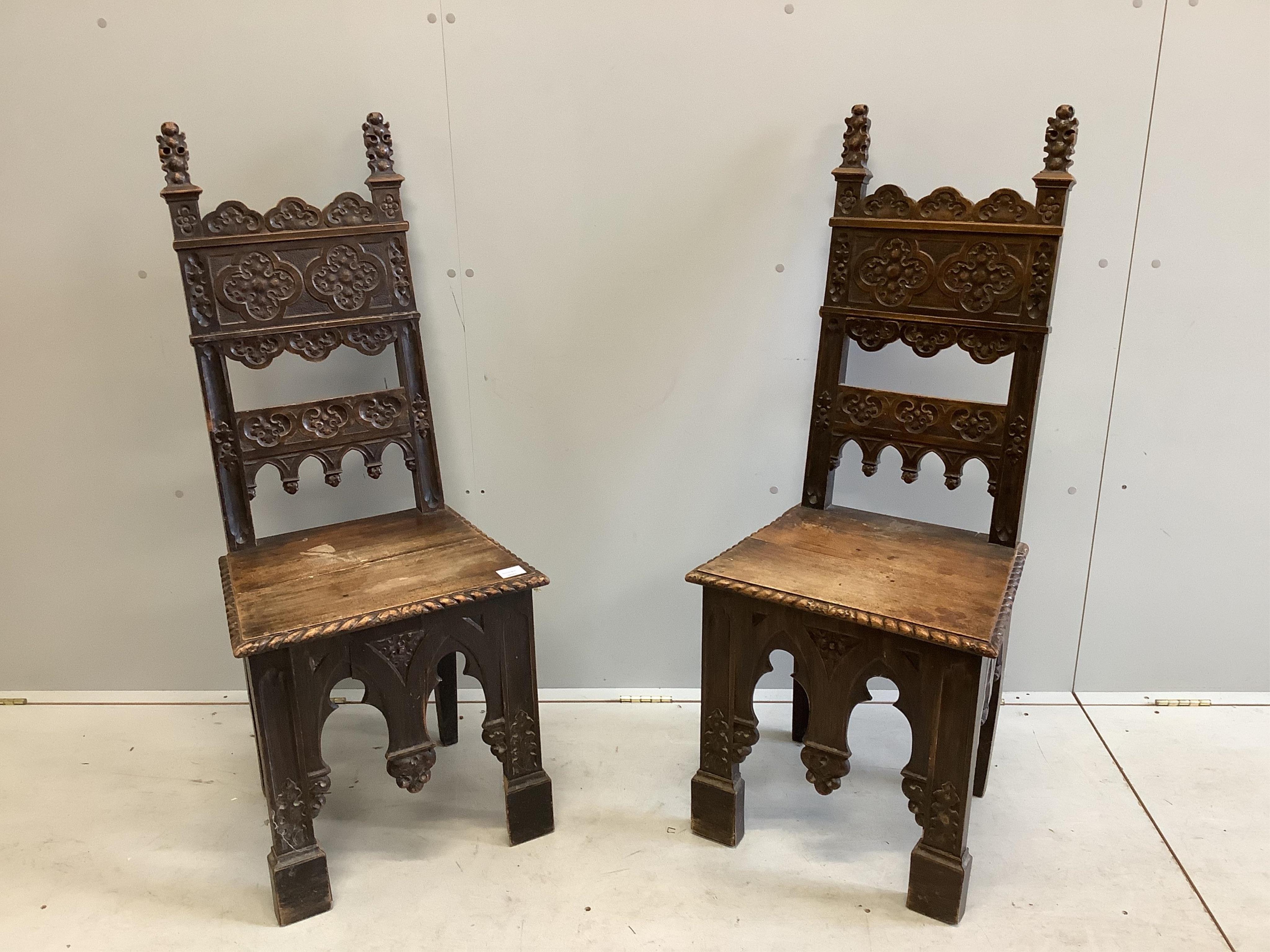 A pair of 19th century Italian walnut hall chairs, width 48cm, depth 39cm, height 118cm. Condition - fair